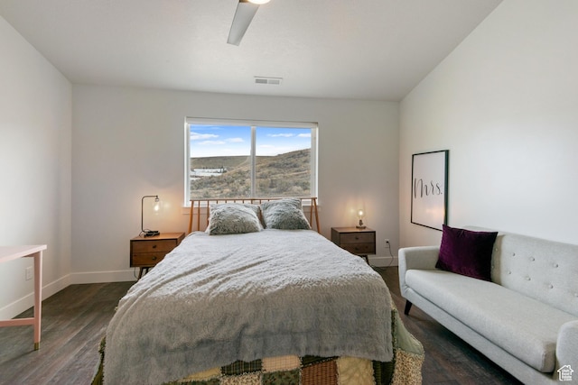 bedroom featuring visible vents, baseboards, wood finished floors, and a ceiling fan