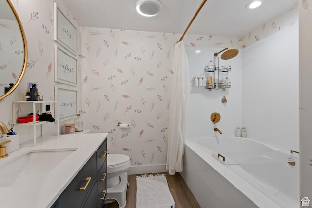 full bath featuring toilet, shower / bath combo, wood finished floors, wallpapered walls, and baseboards