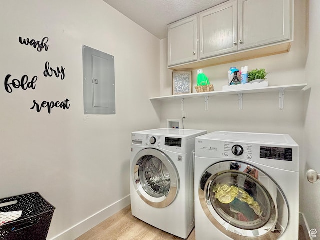 337 S 1540 E, Hyrum, UT 84319 - washroom featuring baseboards, electric panel, light wood-style floors, cabinet space, and washing machine and clothes dryer