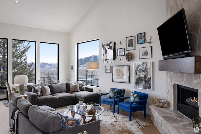 4673 Nelson Ct, Park City, UT 84098 - living room featuring wood finished floors, high vaulted ceiling, a stone fireplace, and recessed lighting