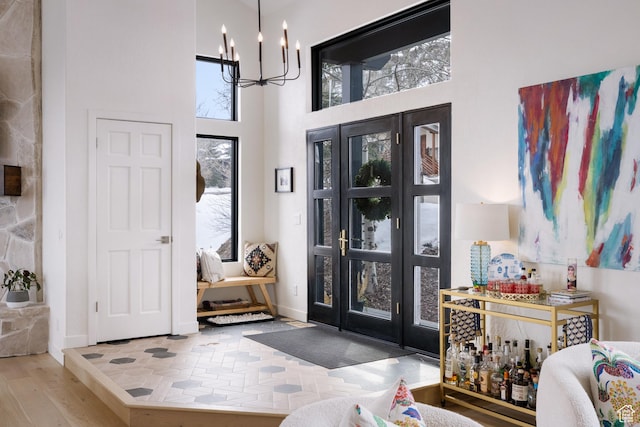 4673 Nelson Ct, Park City, UT 84098 - entrance foyer with a chandelier, a high ceiling, wood finished floors, and baseboards
