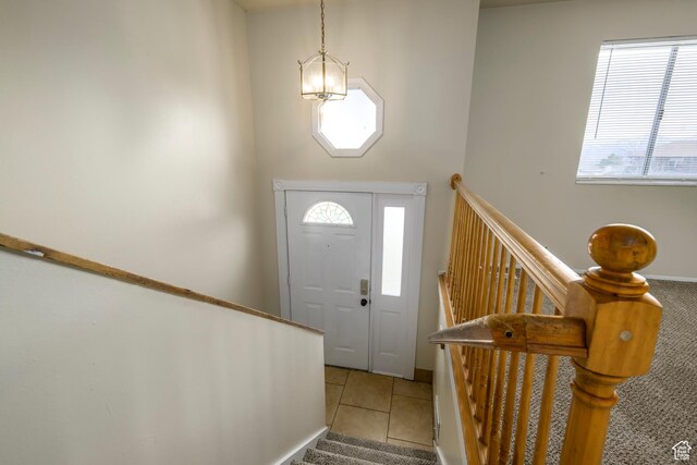 foyer with light tile patterned floors and stairway
