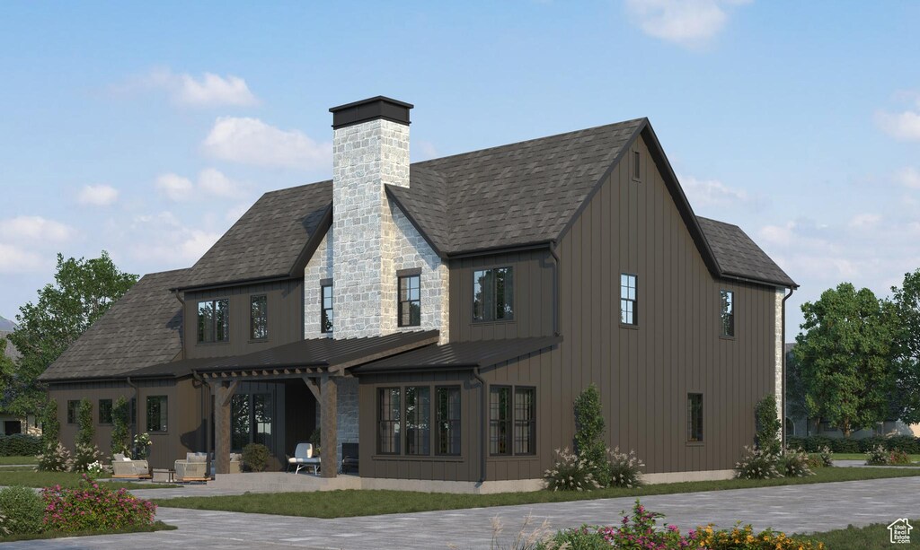 387 S 7900th St E Unit 13, Huntsville, UT 84317 - back of property with stone siding, roof with shingles, board and batten siding, a chimney, and a patio area