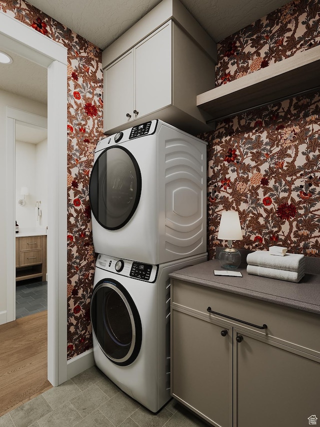 387 S 7900th St E Unit 13, Huntsville, UT 84317 - laundry room with stacked washer / dryer, wallpapered walls, and cabinet space