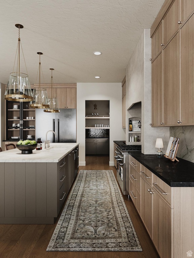 387 S 7900th St E Unit 13, Huntsville, UT 84317 - kitchen featuring light brown cabinets, dark wood-style flooring, a center island with sink, modern cabinets, and a textured ceiling