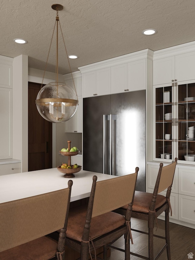 439 S 7900 E Unit 11, Huntsville, UT 84317 - kitchen featuring high quality fridge, white cabinets, recessed lighting, a kitchen breakfast bar, and a textured ceiling