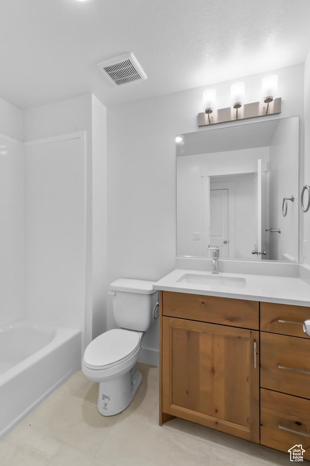bathroom featuring visible vents, toilet, vanity, and baseboards