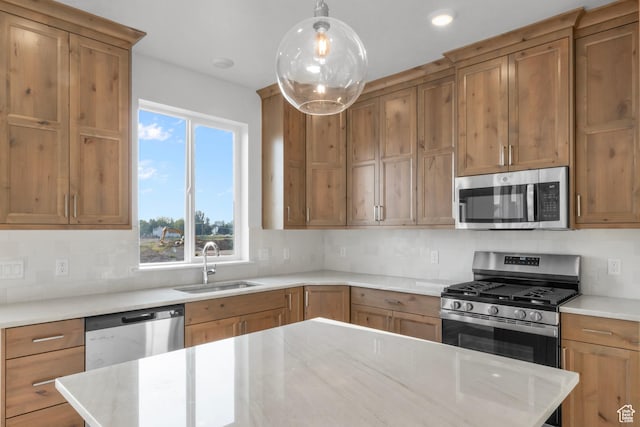kitchen featuring decorative backsplash, stainless steel appliances, and a sink