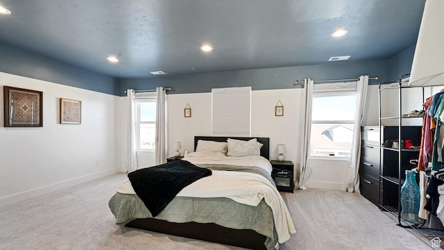 bedroom featuring recessed lighting, light colored carpet, and baseboards