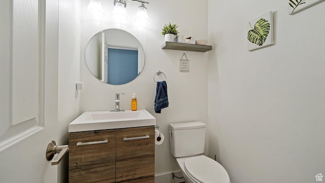 bathroom featuring toilet and vanity