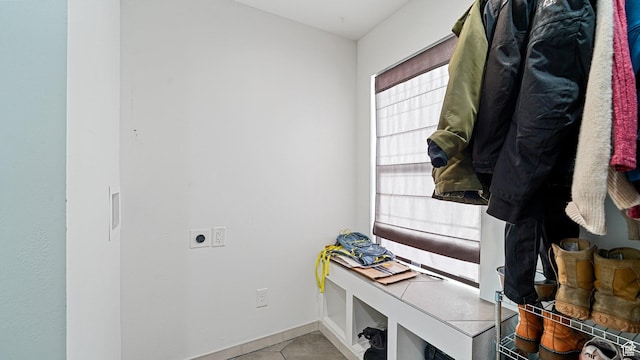 mudroom featuring light tile patterned floors and baseboards