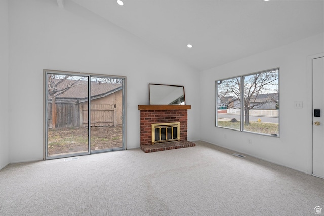 unfurnished living room with a fireplace, recessed lighting, carpet floors, and high vaulted ceiling