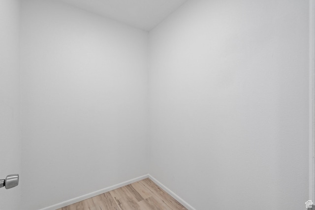 unfurnished room featuring light wood-type flooring and baseboards