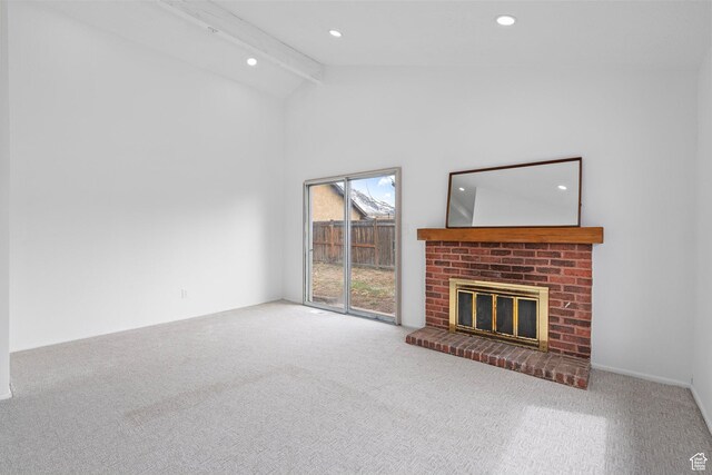 unfurnished living room with beamed ceiling, recessed lighting, a brick fireplace, and carpet floors