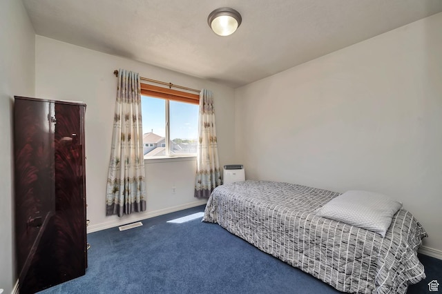 bedroom featuring visible vents, baseboards, and carpet floors