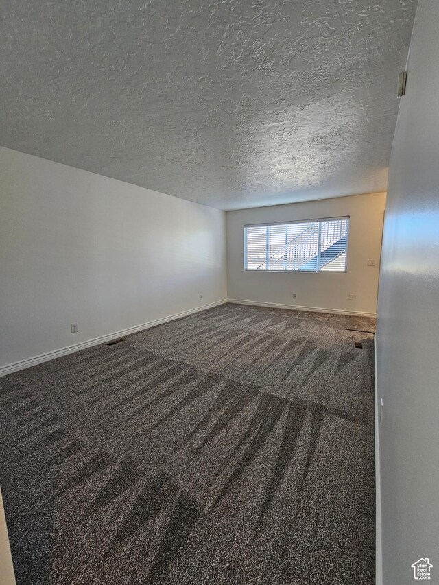 3673 S 2200 W Unit 15, West Valley City, UT 84119 - empty room featuring baseboards, carpet floors, and a textured ceiling