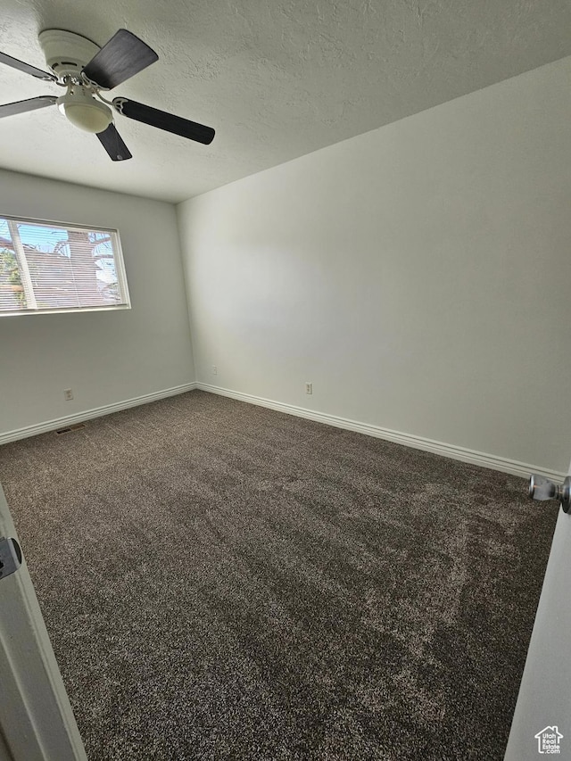 3673 S 2200 W Unit 15, West Valley City, UT 84119 - unfurnished room featuring visible vents, baseboards, ceiling fan, a textured ceiling, and dark carpet