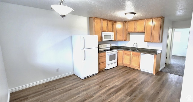 3673 S 2200 W Unit 15, West Valley City, UT 84119 - kitchen with dark countertops, a sink, white appliances, a textured ceiling, and dark wood-style flooring