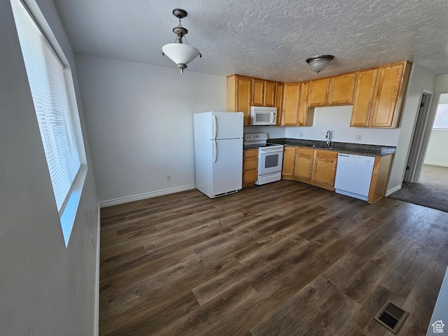 3673 S 2200 W Unit 15, West Valley City, UT 84119 - kitchen with dark countertops, visible vents, dark wood-style floors, white appliances, and a sink