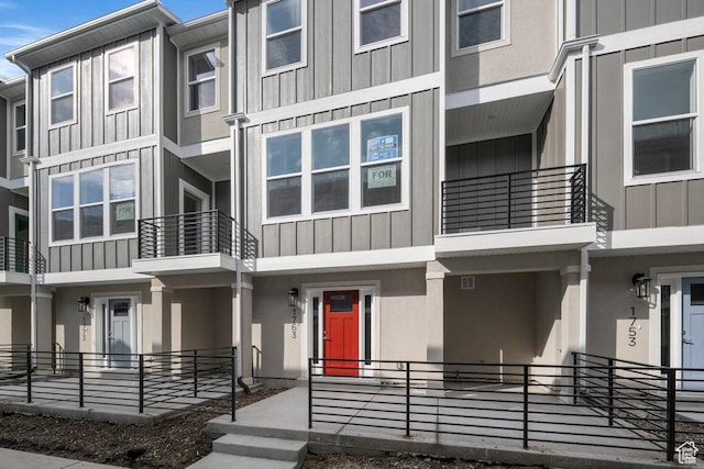 view of property featuring board and batten siding and stucco siding