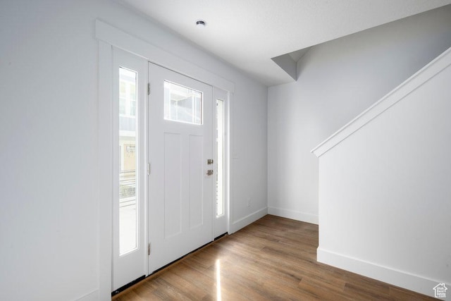 foyer with wood finished floors and baseboards
