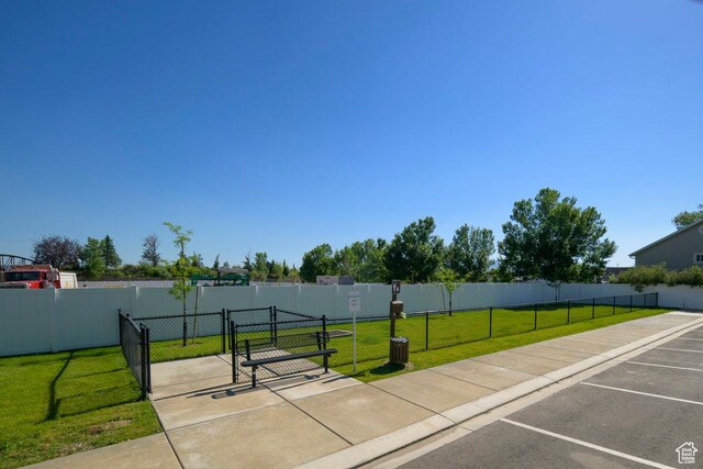 surrounding community with a gate, a lawn, and fence