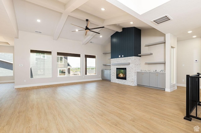502 S Foundation Trl, Cedar City, UT 84720 - unfurnished living room with light wood-style flooring, a glass covered fireplace, ceiling fan, and recessed lighting