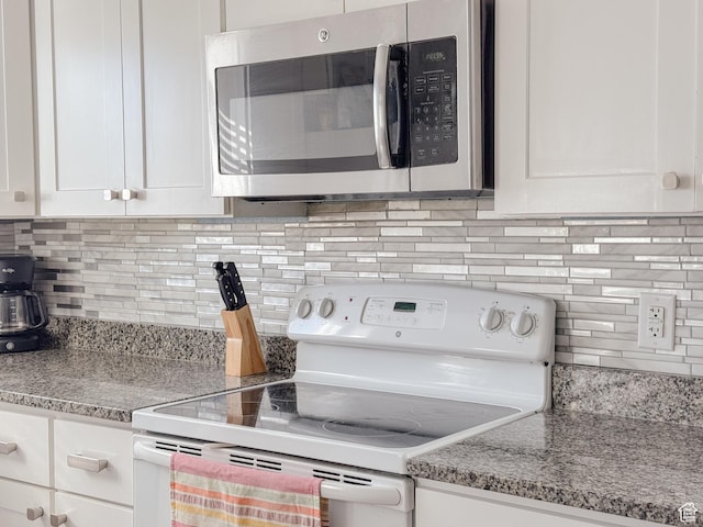 3140 S 4140 W, West Valley City, UT 84120 - kitchen featuring tasteful backsplash, stainless steel microwave, white electric stove, and white cabinetry