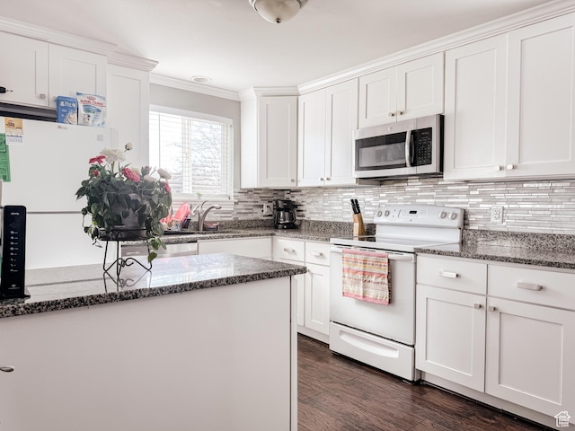 3140 S 4140 W, West Valley City, UT 84120 - kitchen featuring electric range, stainless steel microwave, tasteful backsplash, white cabinets, and dark wood-style flooring