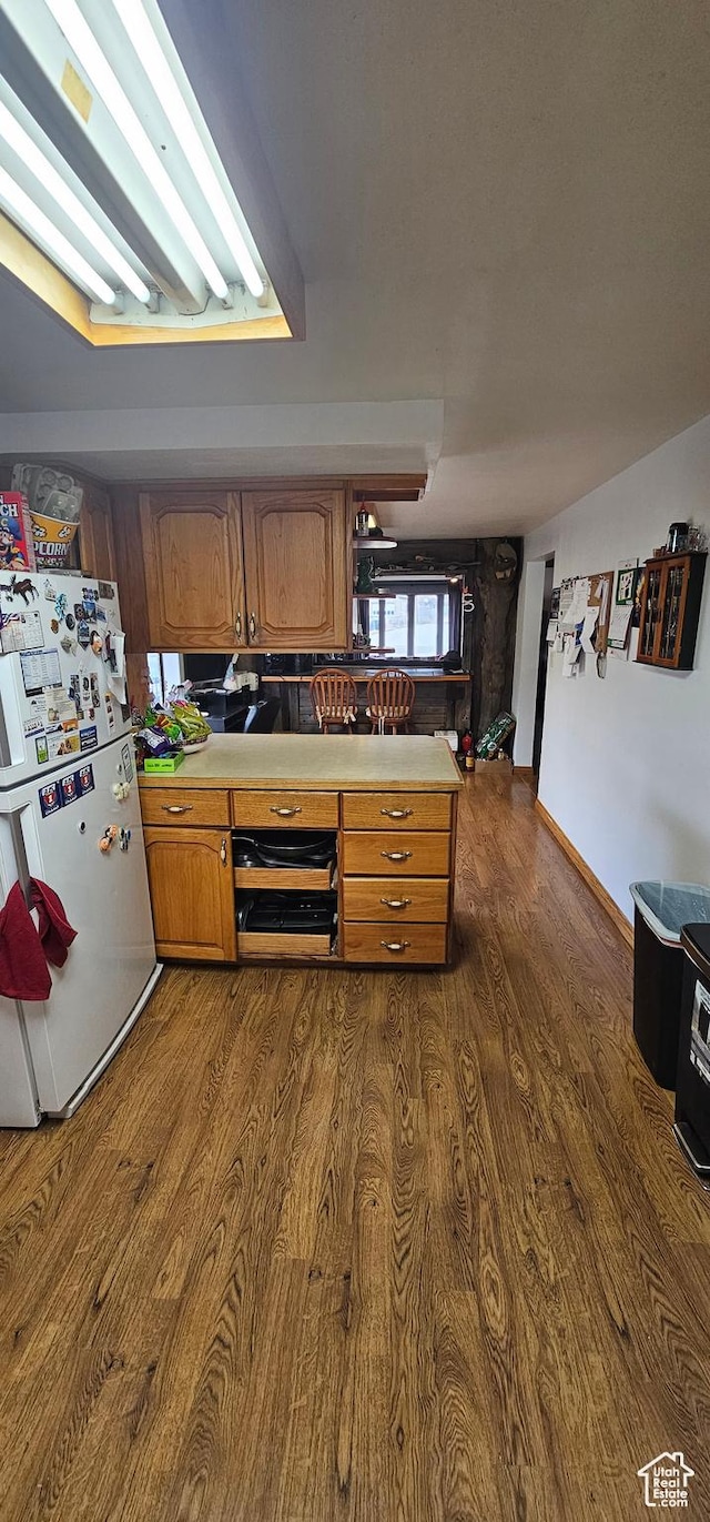 1433 W 2060 N, Helper, UT 84526 - kitchen featuring freestanding refrigerator, dark wood-type flooring, light countertops, and brown cabinetry