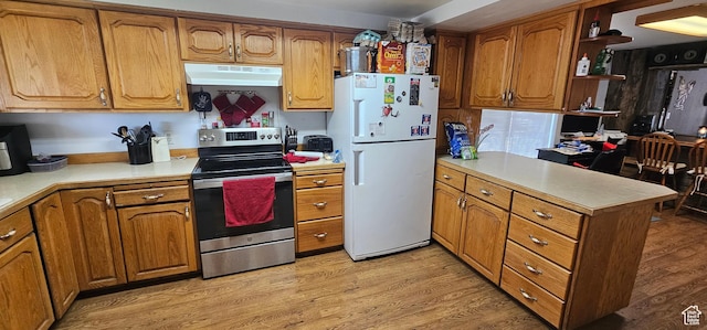 1433 W 2060 N, Helper, UT 84526 - kitchen with freestanding refrigerator, stainless steel range with electric stovetop, under cabinet range hood, a peninsula, and brown cabinetry