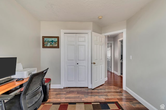 office area featuring baseboards, a textured ceiling, and wood finished floors