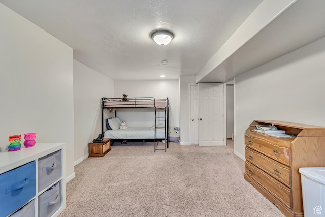 bedroom with baseboards and carpet