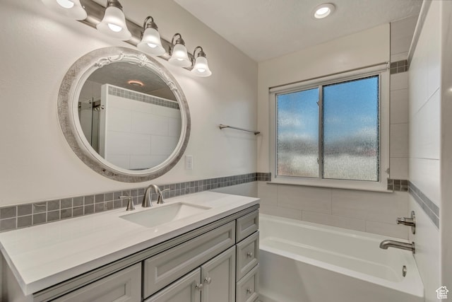 full bathroom with a tub to relax in and vanity