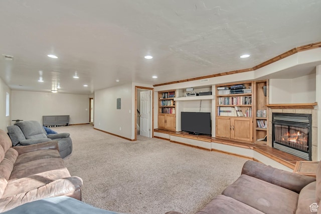 living room featuring recessed lighting, light colored carpet, baseboards, and a lit fireplace