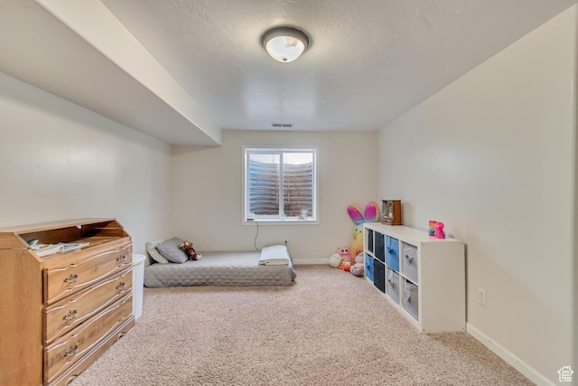 bedroom featuring visible vents, baseboards, and carpet