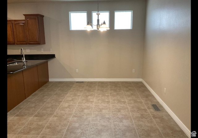 2843 W Pine Cone Ln N, Lehi, UT 84043 - unfurnished dining area with light tile patterned floors, baseboards, visible vents, a sink, and a notable chandelier
