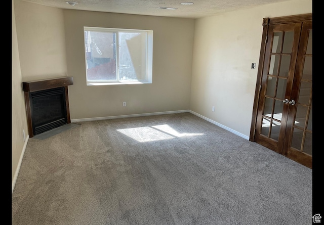2843 W Pine Cone Ln N, Lehi, UT 84043 - unfurnished living room featuring a fireplace with flush hearth, a textured ceiling, french doors, carpet, and baseboards