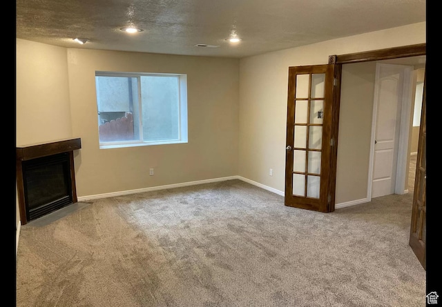 2843 W Pine Cone Ln N, Lehi, UT 84043 - unfurnished living room featuring visible vents, a fireplace with flush hearth, a textured ceiling, carpet flooring, and baseboards