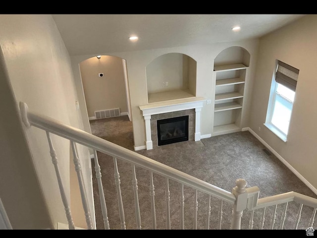 2843 W Pine Cone Ln N, Lehi, UT 84043 - unfurnished living room with built in shelves, carpet, visible vents, baseboards, and a tile fireplace