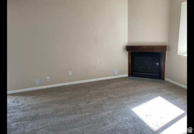 2843 W Pine Cone Ln N, Lehi, UT 84043 - unfurnished living room with a fireplace with flush hearth, baseboards, and carpet