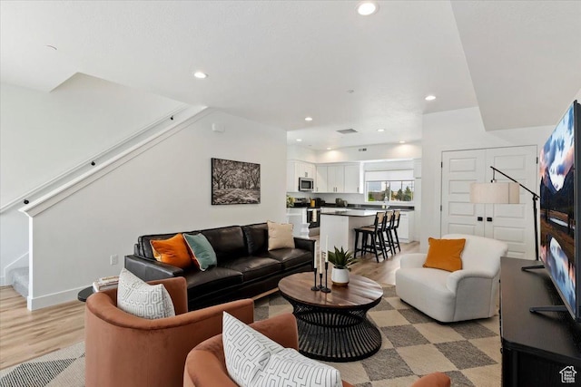 971 W 1700 S Unit 114, Salt Lake City, UT 84104 - living room featuring recessed lighting, baseboards, light wood-style flooring, and stairs