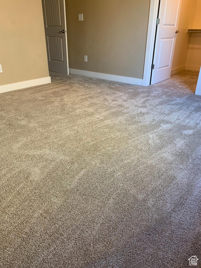 carpeted spare room with baseboards