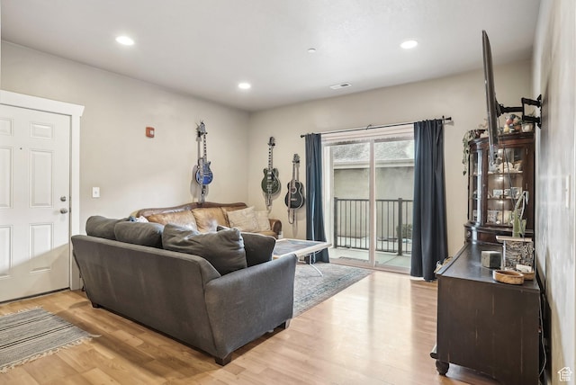 living room with visible vents, light wood finished floors, and recessed lighting