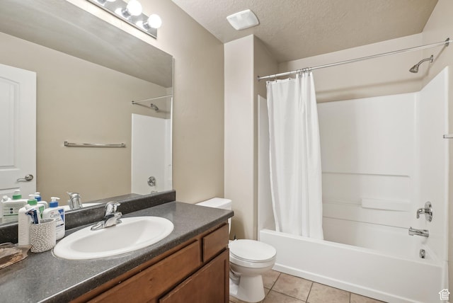 bathroom with tile patterned floors, shower / bathtub combination with curtain, toilet, vanity, and a textured ceiling