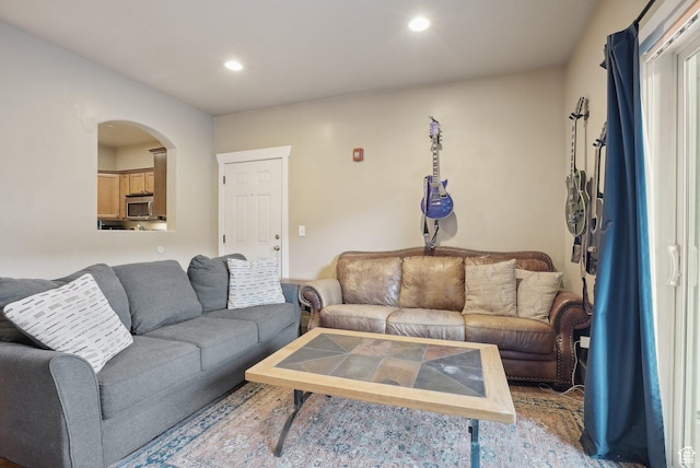 living area with arched walkways and recessed lighting