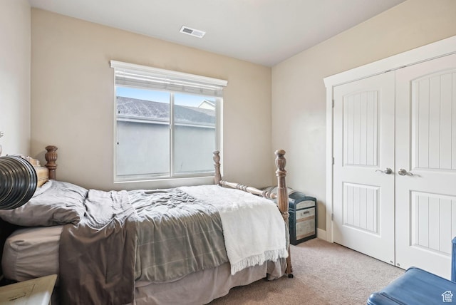 carpeted bedroom with a closet and visible vents