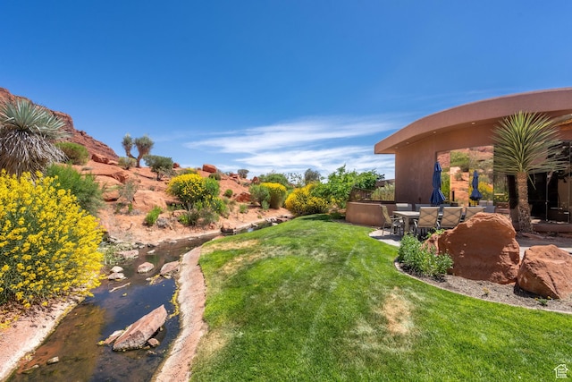 2336 W Entrada Trl Unit 44, St George, UT 84770 - view of grassy yard featuring a patio area
