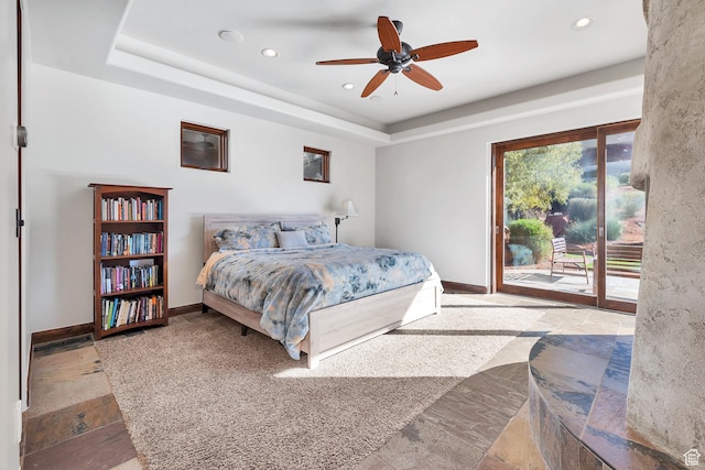 2336 W Entrada Trl Unit 44, St George, UT 84770 - bedroom with access to exterior, baseboards, recessed lighting, stone tile flooring, and a tray ceiling