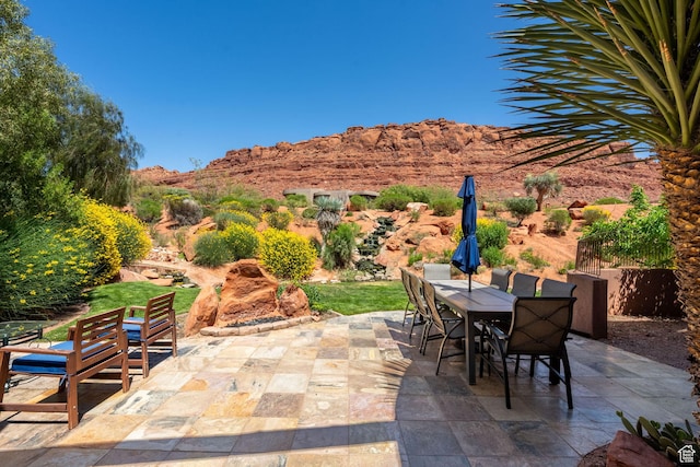 2336 W Entrada Trl Unit 44, St George, UT 84770 - view of patio featuring outdoor dining space and a mountain view